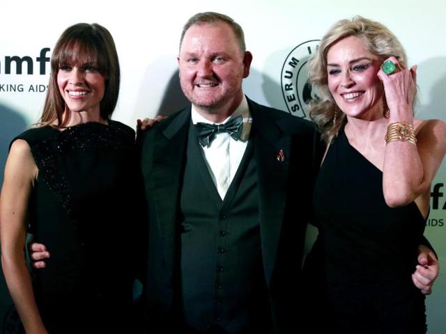 Swank and Stone flank the CEO of amfAR.