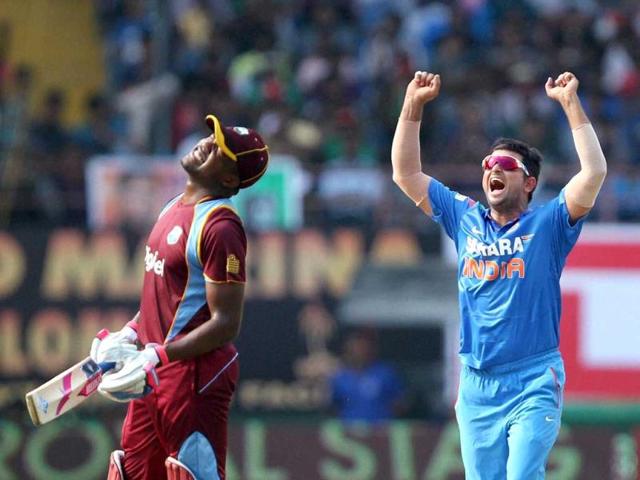Suresh Raina celebrates the wicket of Lendl Simmons of West Indies during the 1st ODI match in Kochi. (PTI photo)