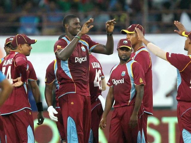 West Indies bowler Jason Holder with team mates celebrates the wicket of Shikhar Dhawan during the 1st ODI match in Kochi. (PTI photo)