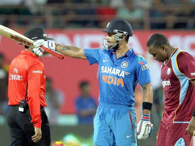 Virat Kohli celebrate his fifty runs against West Indies during the 1st ODI in Kochi. (PTI photo)