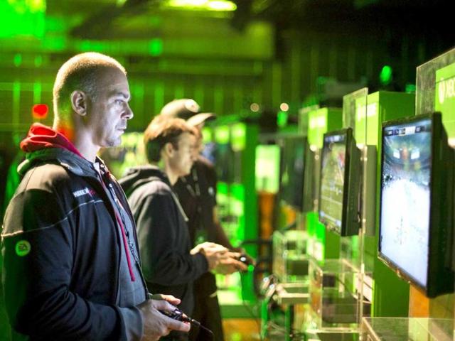 Fans play video games on Xbox One consoles during a midnight launch event in New York. (Reuters Photo)
