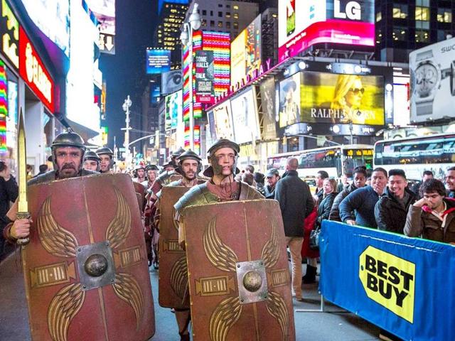 Actors dressed as characters from the Xbox One game "Ryse: Son of Rome" walk through Times Square at an event celebrating the midnight launch. (Reuters Photo)