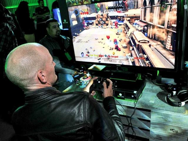 Video game fans try out the new Xbox game console at Xbox One Official Launch Celebration at Milk Studios in Los Angeles. (AP Photo)
