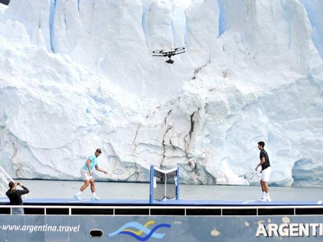 Novak Djokovic (R) of Serbia and Rafael Nadal of Spain play an exhibition tennis match at a court set up on the deck of a ship, as the Perito Moreno glacier is seen in the background, near the Patagonian city of El Calafate. Djokovic and Nadal are in Argentina to attend a farewell event on Sunday for Argentina's David Nalbandian, who is retiring from professional tennis. (Reuters)
