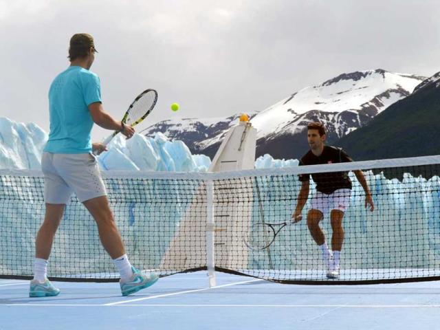 In this picture released by Argentina's Ministry of Tourism, tennis players Rafael Nadal, left, and Novak Djokovic play an exhibition match on a boat in front of Glacier Perito Moreno near El Calafate, Argentina. (AP Photo)
