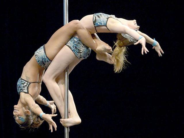 Brazilian pole dance couple Ekaterina Malykhina and Tallyta Torres compete en route to wining first place in the South America 2013 Pole Dance competition in Buenos Aires. (AFP Photo)