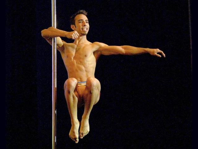 Venezuelan pole dancer Gregoris Garcia competes en route to winning in the Male South America 2013 Pole Dance competition in Buenos Aires. (AFP Photo)