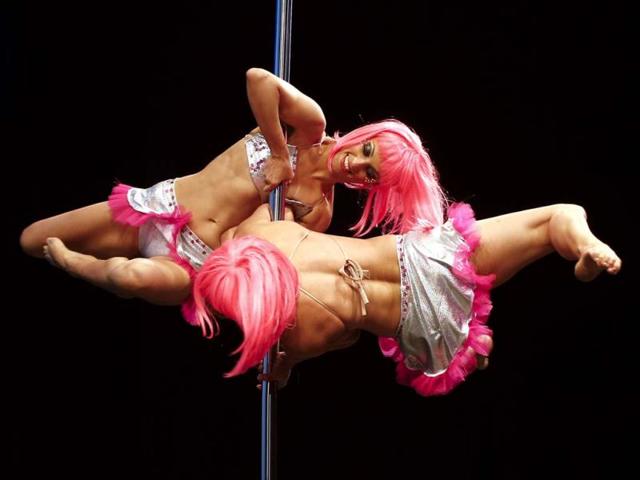 Pole dance couple Polet Cuevas and Munira Hasen of Chile perform in the doubles' category of the Miss Pole Dance South America 2013 competition in Buenos Aires, Argentina. (AP Photo)