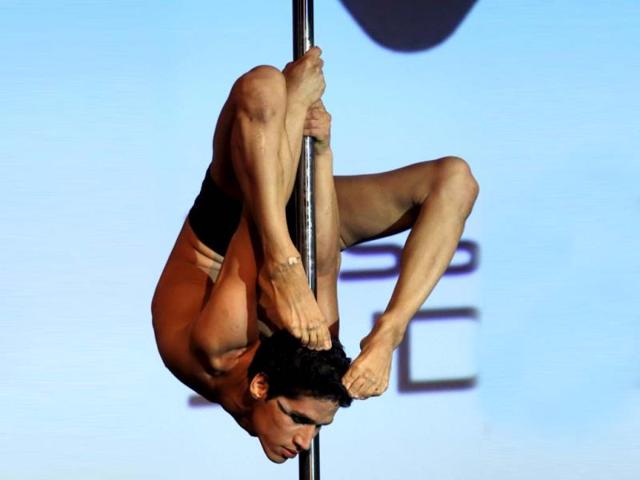 Renzo Escudero Zerga of Peru performs in the men's category at the Miss Pole Dance South America competition in Buenos Aires. (Reuters)