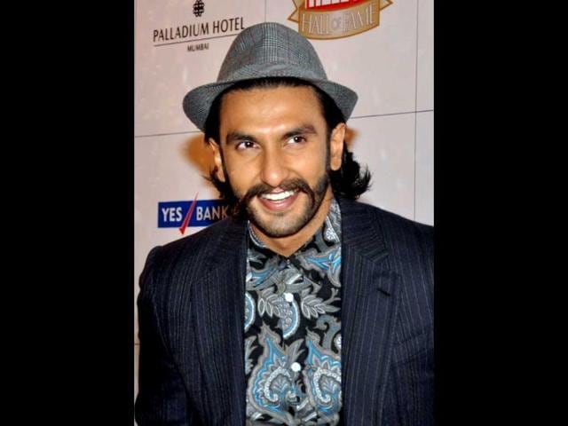 With a hat and his trademark moustache-beard, Ranveer Singh stands out from the tuxedo crowd.