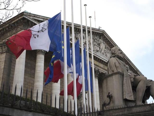 French flags and European flag fly half-mast in front of the French National Assembly in Paris, a day after the death in Johannesburg of South African former president Nelson Mandela. (AFP)