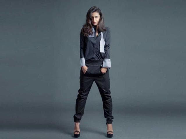 Anita walia, the founder of The Perpetual dons a shirt with a built in bow tie and contrast french cuffs. The trousers are "drop crotch, banana fit" as described by the designer.