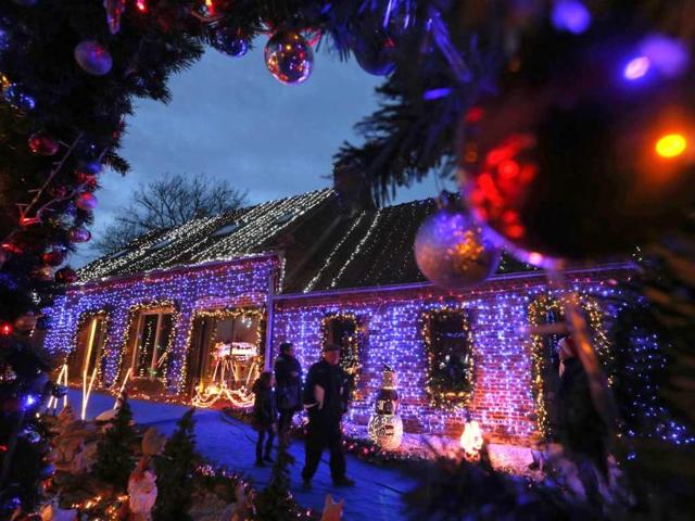 People look at Christmas decorations at the home of Virginie and Jessy Kazmierski in Paillencourt, near Cambrai, northern France. (Reuters)