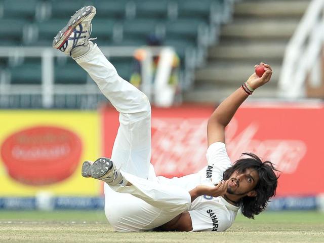 Ishant Sharma falls on the ground after fielding off his own bowling during the final day of the first Test against South Africa at the Wanderers Stadium. (AP Photo)