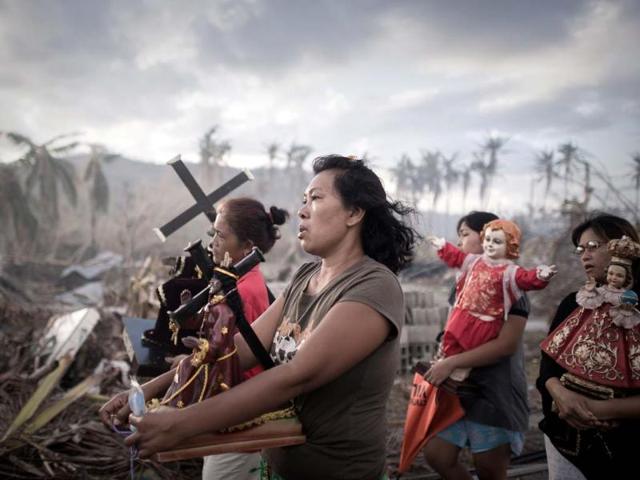 Survivors of super typhoon Haiyan march during a religious procession in Tolosa on the eastern Philippine island of Leyte in November, a week after Haiyan devastated the area, affecting an estimated 13 million people. (AFP)