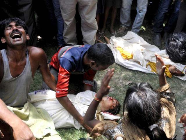 Grief-stricken family members react over the bodies of their children who died after consuming a free mid-day meal at a school in July in Saran district, Bihar. (HT Photo)