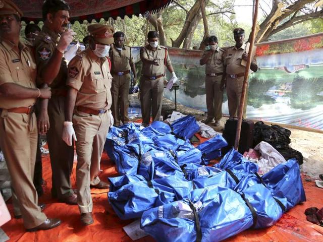 Police officers stand by the bodies of passengers killed in the train accident at Kothacheruvu, about 155 kilometers north of Bangalore. (AP)