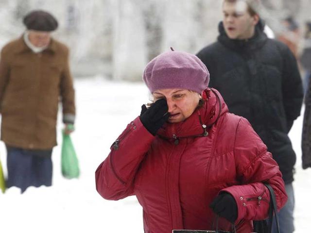 A Volgograd resident walks crying in Volgograd, Russia. A bomb blast tore through a trolleybus in the city of Volgograd on Monday morning, killing at least 10 people a day after a suicide bombing that killed at least 17 at the city's main railway station. (AP Photo)