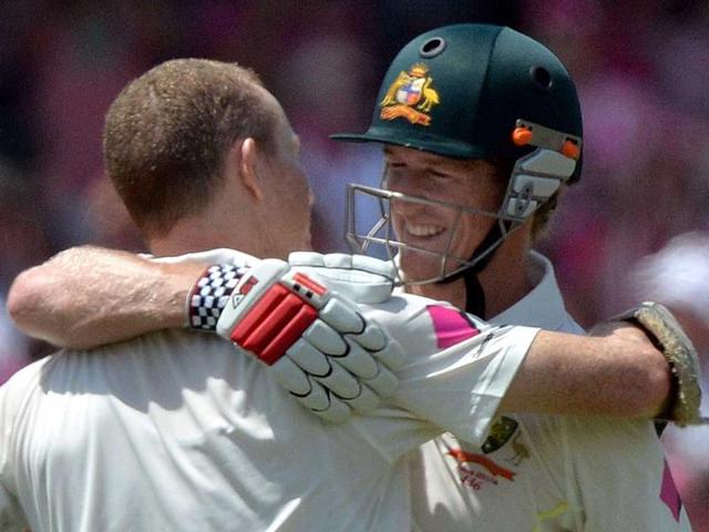 Australia's batsman George Bailey (R) hugs Chris Rogers (L) to congratulate him for his century against England on the third day of the fifth Ashes cricket Test. (AFP Photo)