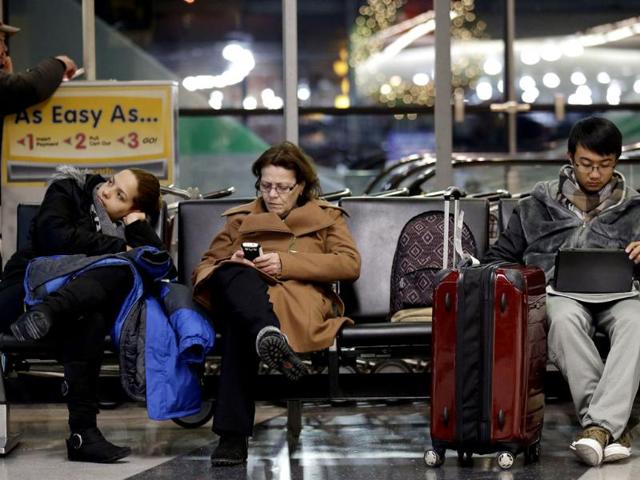 Travelers deal with long waits and flight cancellations at O'Hare International Airport in Chicago. (AP Photo)