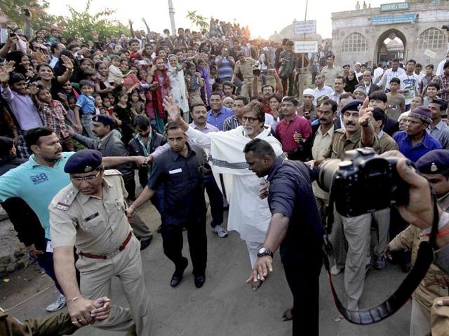 Amitabh Bachchan waves to his fans as he leaves after shooting for a Gujarat tourism promotional film with Shoojit Sircar at Sarkhej Roja, a city monument in Ahmedabad. (AP Photo)