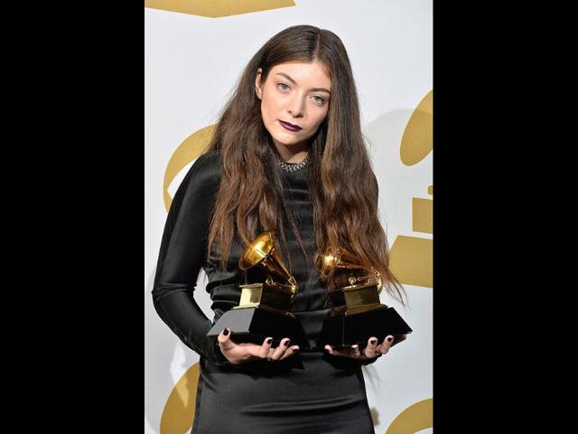Singer Lorde, winner of the Song of the Year Award for Royals and the Best Pop Solo Performance Award for Royals, poses with the awards.