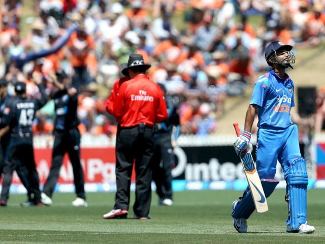 Ajinkya Rahane (R) walks off the field after being dismissed during the fourth ODI against New Zealand at Seddon Park in Hamilton. (AFP Photo)