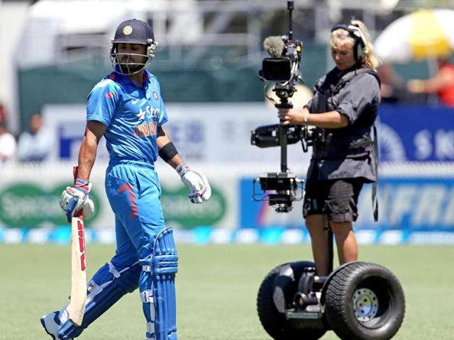 Virat Kohli (L) walks off the field after being dismissed during the fourth ODI against New Zealand at Seddon Park in Hamilton. (AFP Photo)