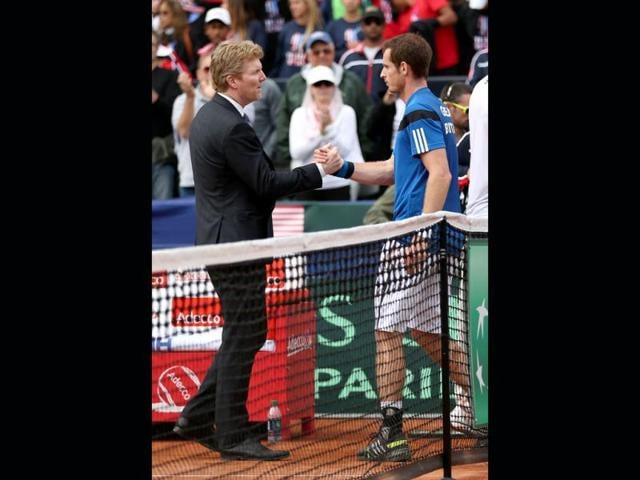 Andy Murray of Great Britain shakes hands with United States captain Jim Courier after his four set victory against Sam Querrey of the United States during day three of the Davis Cup World Group first round in San Diego. (AFP Photo)