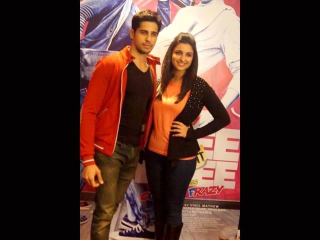 Parineeti and Siddharth pose together.