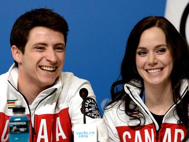 Canadian figure skating dance pair Tessa Virtue and Scott Moir speak at a press conference by Canada's figure skating team in Sochi. (AFP photo) 