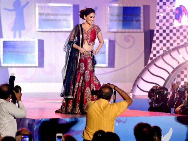 Madhuri Dixit Nene displays a creation by designer Manish Malhotra during a fashion show for 'Save & Empower The Girl Child' in Mumbai. (AFP)