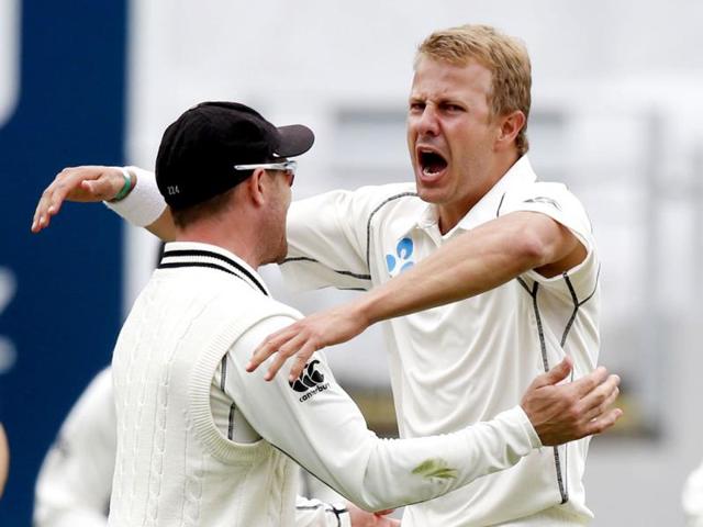 New Zealand's Neil Wagner (R) and Brendon McCullum (L) celebrate dismissing India's Murali Vijay on day two of the first Test against New Zealand at Eden Park in Auckland. (Reuters Photo)