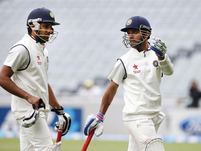 Ajinkya Rahane (R) and Rohit Sharma (L) chat as they leave the field due to bad light on day two of the first Test against New Zealand at Eden Park in Auckland. (Reuters Photo)