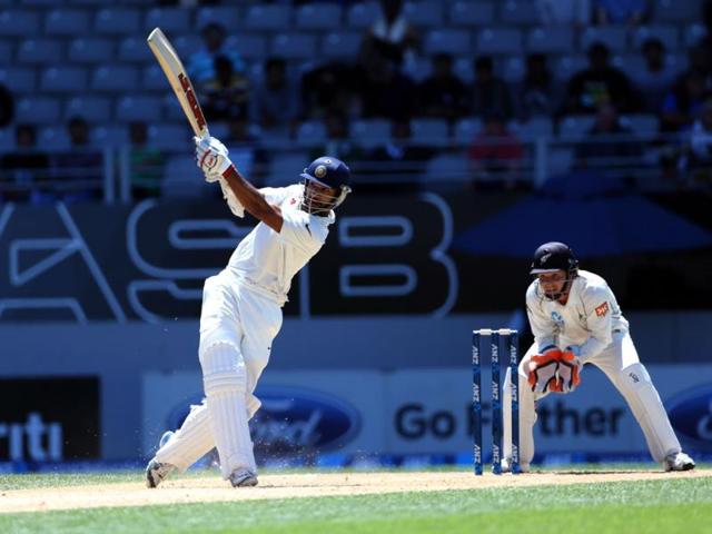 Shikhar Dhawan bats as New Zealand's BJ Watling looks on during day four of the first Test match at Eden Park in Auckland. (AFP Photo)
