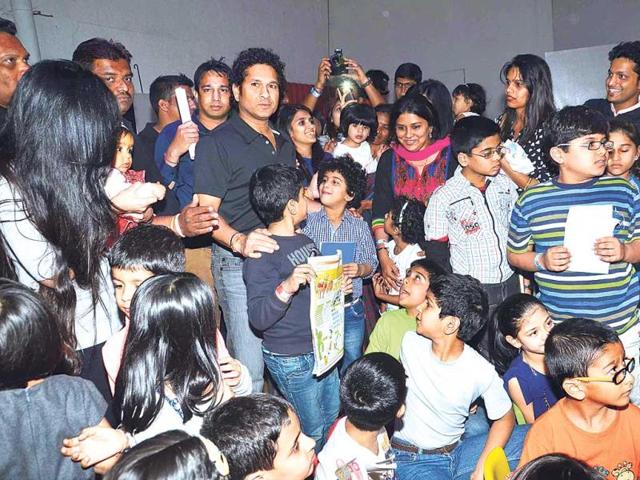 Sachin Tendulkar, surrounded by a bunch of kids at an event in Mumbai.