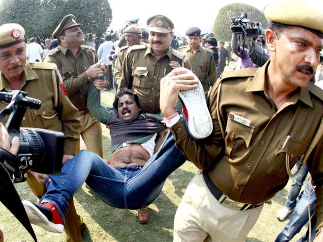 Police detain one of the Telangana supporters during a protest at Vijay Chowk in New Delhi. (PTI Photo)