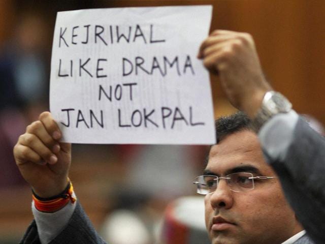 A BJP MLA shows a placard in the Delhi Assembly during its special session called for anti-corruption jan lokpal bill in New Delhi on February 14, 2014. (PTI photo)