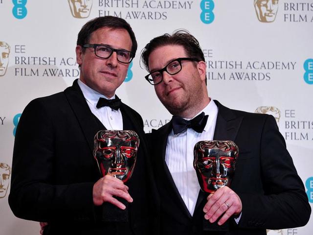 US director David O Russell and writer Eric Warren Singer pose with their awards for an original screenplay for the film American Hustle at the BAFTA British Academy Film Awards at the Royal Opera House in London on February 16, 2014. (AFP Photo)