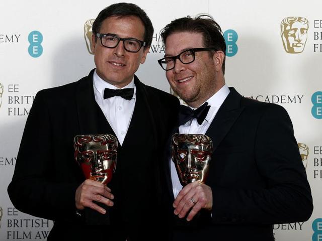 Writers Eric Warren Singer and David O. Russell celebrate winning the Original Screenplay category for American Hustle at the British Academy of Film and Arts (BAFTA) awards ceremony at the Royal Opera House in London on February 16, 2014. (Reuters Photo)