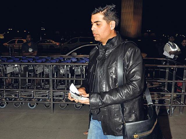 Karan Johar heads to the check-in counter at the Mumbai airport.