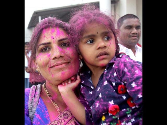 TRS supporters celebrate with colours the passage of Telangana bill in the Lok Sabha in New Delhi. (PTI photo)