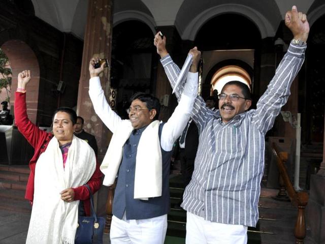 Telangana MPs Gunda Sudharani, Nageshwar Rao, and Ramesh Rathore celebrate the passage of Telangana bill in the Lok Sabha. (HT Photo/Sonu Mehta)