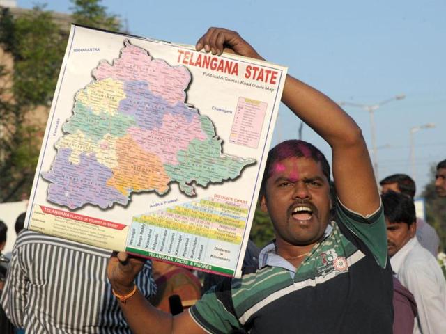 A TRS supporter holds a map as he celebrates the planned creation of Telangana state in Hyderabad. (AFP photo)