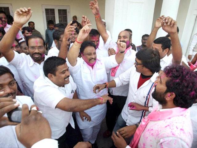 TRS activists dance as they celebrate with colours the passage of Telangana bill in the Lok Sabha, in New Delhi. (PTI photo)