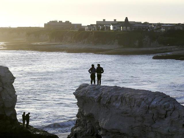 Visitors-watch-the-sunset-from-atop-the-bluffs-at-Natural-Bridges-State-Beach-in-Santa-Cruz-California-AP-Photo-Marcio-Jose-Sanchez Visitors-watch-the-sunset-from-atop-the-bluffs-at-Natural-Bridges-State-Beach-in-Santa-Cruz-California-AP-Photo-Marcio-Jose-Sanchez