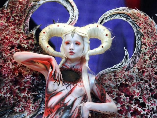 A body-painted model displays a creation during an art show as part of the International Beauty Expo 'Nevskie Berega' (Neva River Banks) in St Petersburg. (AFP)