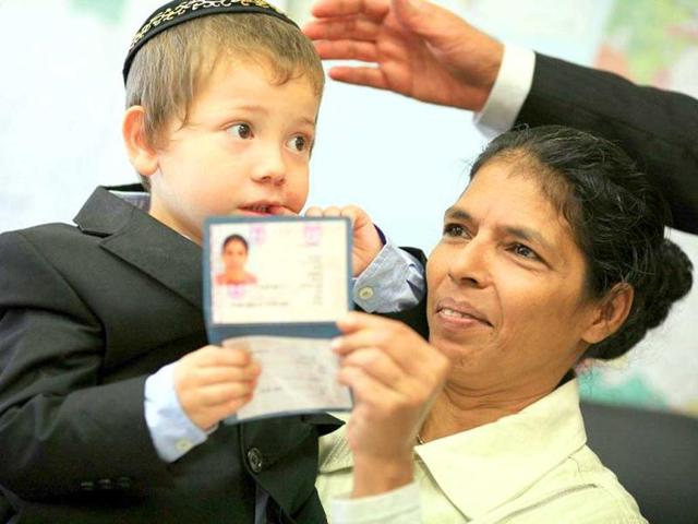 Moshe-Holtzberg-an-Israeli-child-whose-parents-were-killed-in-the-Mumbai-India-is-held-by-his-Indian-nanny-Sandra-in-this-September-13-2010-file-photo-in-Jerusalem-AFP-Photo
