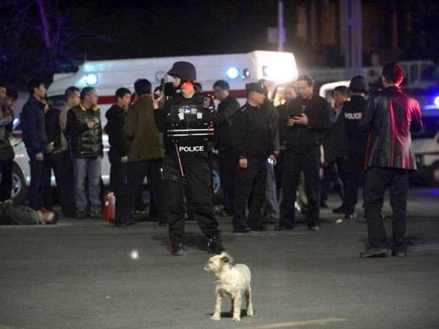 A-policeman-stands-guard-near-a-man-who-was-shot-dead-by-police-lying-on-a-street-after-a-group-of-armed-men-attacked-people-at-Kunming-railway-station-Yunnan-province-Reuters-Photo