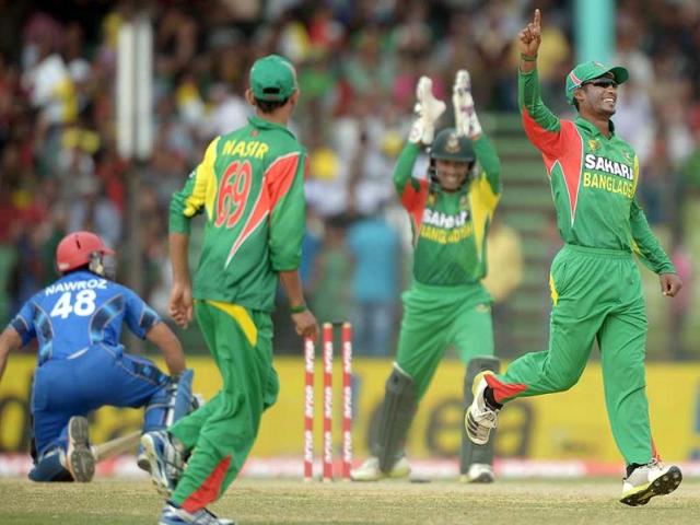 Bangladeshi fielder Naeem Islam (R) celebrates the dismissal of Afghan batsman Nawroz Mangal (L) during the fifth match of the Asia Cup at the Khan Shaheb Osman Ali Stadium in Fatullah. (AFP Photo) Bangladeshi fielder Naeem Islam (R) celebrates the dismissal of Afghan batsman Nawroz Mangal (L) during the fifth match of the Asia Cup at the Khan Shaheb Osman Ali Stadium in Fatullah. (AFP Photo)